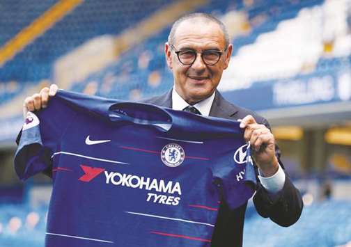 New Chelsea manager Maurizio Sarri poses with the club shirt a the Stamford Bridge in London yesterday. (Reuters)