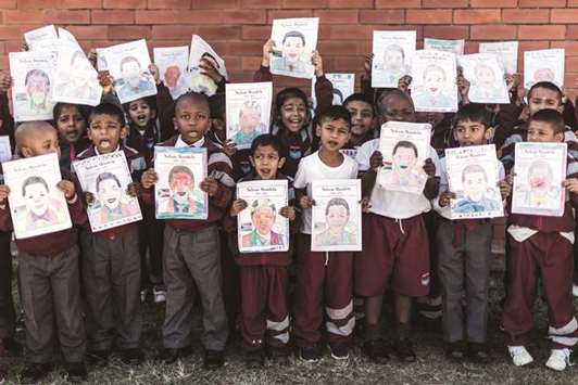 A group of Grade R learners from Northlen Primary school hold posters of former president Nelson Mandela as they sing u201cHappy Birthday Nelson Mandela, We love youu201d in Durban yesterday.