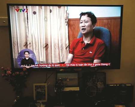 An image of Vietnamese former oil executive Trinh Xuan Thanh is seen on a TV screen on state-run television VTV.