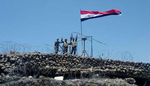 Syrian forces of President Bashar al Assad are seen celebrating on al-Haara hill in Quneitra area.