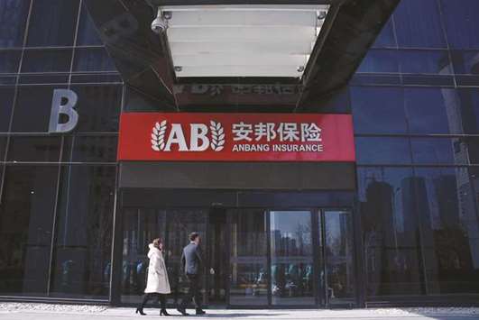 People enter the office of Anbang Insurance Group in Beijing. The insurer is looking to offload overseas properties worth about $10bn to shore up its balance sheet as part of a government-backed rescue, sources said yesterday.