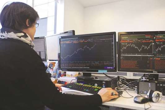 A trader is seen at the London Stock Exchange. The FTSE 100 was down 0.1% to 7,683.97 points yesterday.