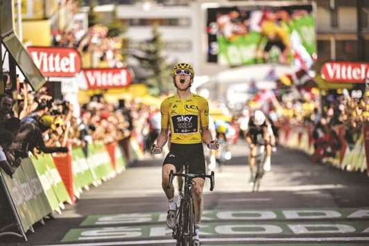 Great Britainu2019s Geraint Thomas celebrates as he crosses the finish line to win the 12th stage of the Tour de France at lu2019Alpe du2019Huez, France, yesterday. (AFP)