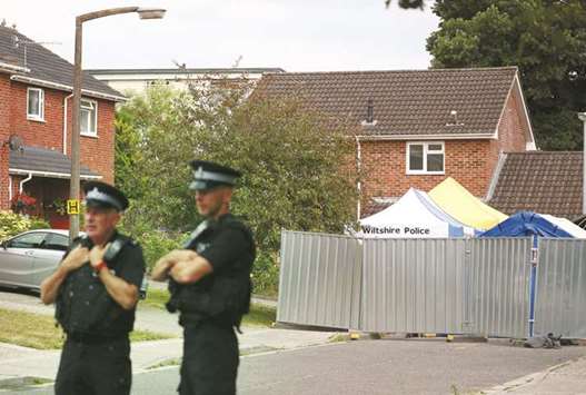 Police officers stand on duty outside Sergei Skripalu2019s home in Salisbury yesterday.