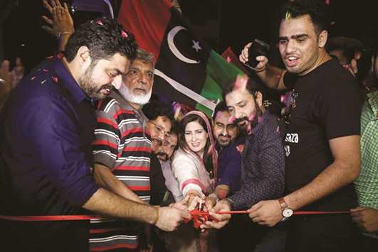 Shehla Raza, the nominated candidate of the Pakistan Peoples Party (PPP) for the National Assembly seat from Karachi, along with party workers, cuts a ribbon to inaugurate the campaign office in her constituency.