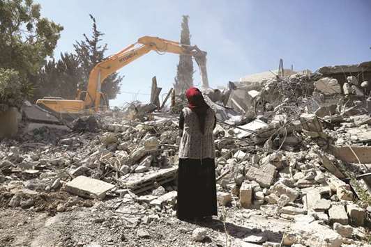 Fawzia stands on the ruins of her house, after her ex-husband demolished the dwelling to not face the prospect of Israeli settlers moving in after he lost a land ownership case in Israeli courts, in the east Jerusalem neighbourhood of Beit Hanina yesterday.