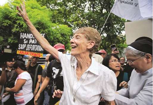 Patricia Fox waves to her supporters before filing a petition calling for the review of her deportation case at the Department of Justice in Padre Faura, Metro Manila, on May 25, 2018.