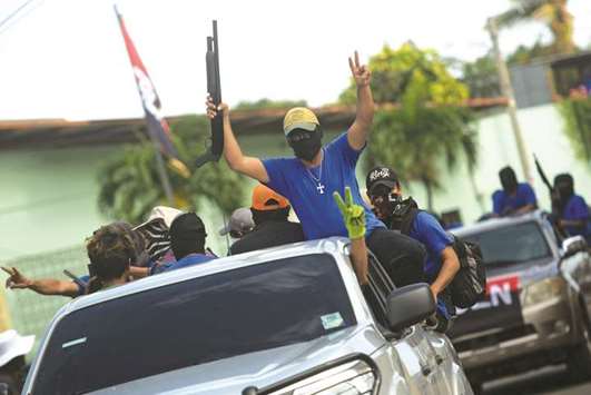 Paramilitaries flash the u201cVu201d sign from a truck at Monimbo neighbourhood in Masaya, Nicaragua following clashes with anti-government demonstrators.