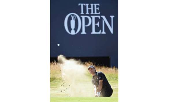 US golfer Kevin Kisner plays out of a green-side bunker on the 18th hole during his first round 66 on day one of The 147th Open Golf Championship at Carnoustie yesterday.