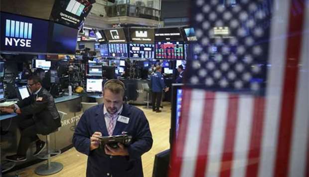 Traders work ahead of the closing bell on the floor of the New York Stock Exchange on Thursday. Stocks were slightly down on Thursday, the day President Donald Trump criticised the Federal Reserve and expressed his disappointment concerning interest rate hikes.