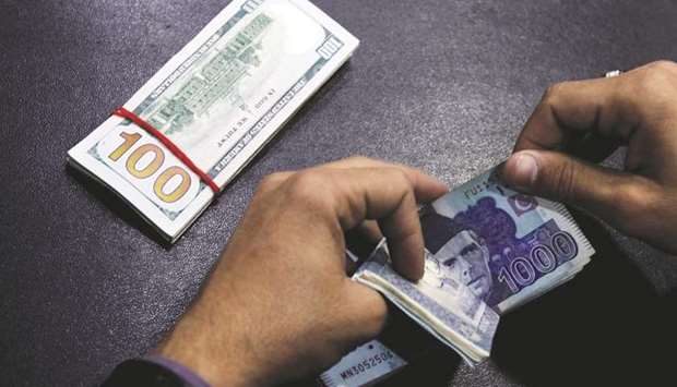 A currency trader counts Pakistani rupee notes in preparation for an exchange with US dollars in Islamabad. Pakistanu2019s economy expanded at 5.8% in the last fiscal year, its quickest pace in 13 years, but the rupee has been devalued four times since December.