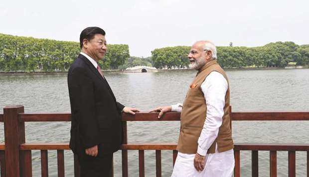 Indiau2019s Prime Minister Narendra Modi (right) and Chinese President Xi Jinping take a walk together along the East Lake, in Wuhan (file). Both leaders will likely take stock of the agreements and deals clinched on the sidelines of the Shanghai Co-operation  Organisation and Wuhan summits during the Brics summit in Johannesburg next week.