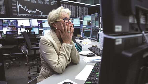 A trader monitors financial data at the Frankfurt Stock Exchange. The DAX 30 closed down 1.0% to 12,561.42 points yesterday.