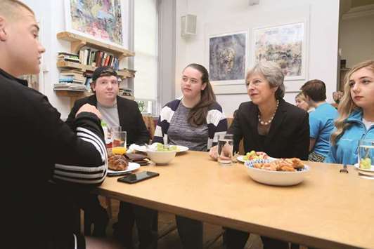 Prime Minister Theresa May speaks with people from the Belfast Youth Forum during her visit to the Crescent Arts Centre in Belfast, Northern Ireland, yesterday.