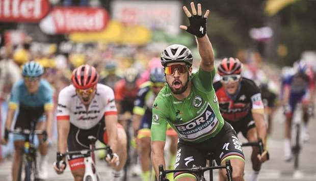 Slovakiau2019s Peter Sagan, wearing the best sprinteru2019s green jersey, celebrates as he crosses the finish line to win the 13th stage of the Tour de France in Valence yesterday. (AFP)