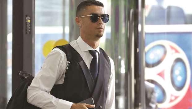 Portugal star Cristiano Ronaldo walks towards a check-in counter before the departure from Zhukovsky International Airport in Moscow yesterday. (Reuters)