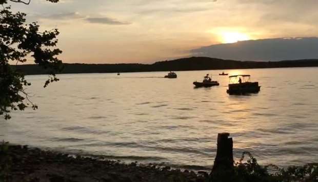 Rescue personnel work after an amphibious ,duck boat, capsized and sank, at Table Rock Lake near Branson, Stone County, Missouri, US in this still image obtained from a video on social media