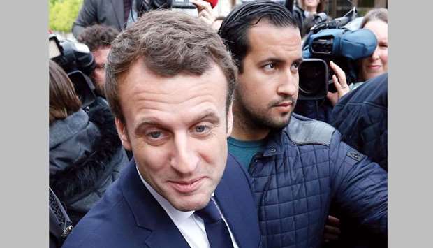 This picture taken on May 5 last year shows Macron, then a candidate in the 2017 presidential election, with Benalla, who was then the campaign head of security, at a visit in Rodez, France.