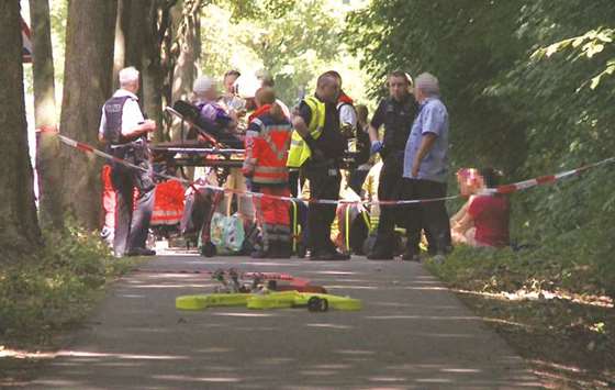 Passengers of the bus receive medical treatment in Kuecknitz, near Luebeck in northern Germany, after the knifing attack.