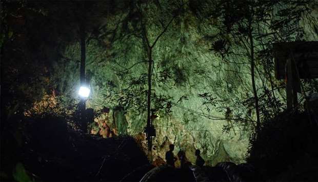Thai soldiers stand at the mouth of Tham Luang cave, at the Khun Nam Nang Non Forest Park in Chiang Rai province
