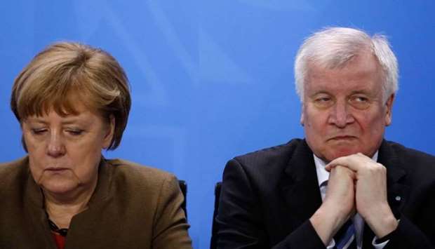 German Chancellor Angela Merkel (L) and German Interior Minister and leader of the CSU Party Horst Seehofer
