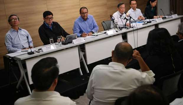 Minister for Communications and Information S. Iswaran (centre) is seen with ministers and officials at a press conference in Singapore last month regarding the cyber attack. File picture