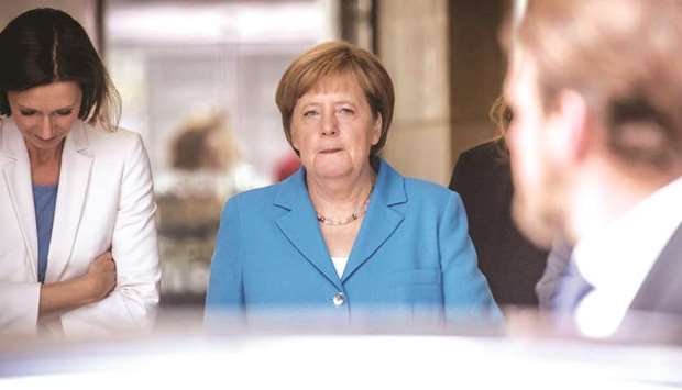 Merkel leaves the German public television ZDF office in Berlin after recording the traditional u2018summer interviewu2019 yesterday, prior to a leadership meeting of her centre-right CDU party. Her CDU and its conservative Bavarian CSU allies held separate meetings yesterday to weigh the results of last weeku2019s EU summit.
