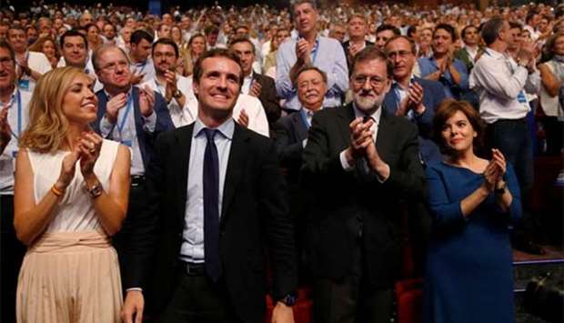 Pablo Casado reacts after being elected as the new leader of Spain's People's Party as his wife Isabel Torres Orts and former Spanish prime minister Mariano Rajoy applaud, in Madrid on Saturday.