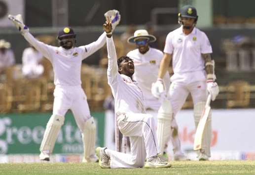 Sri Lankan spinner Akila Dananjaya (centre) celebrates after dismissing South Africau2019s Dale Steyn during second Test at the Sinhalese Sports Club in Colombo yesterday. (AFP)