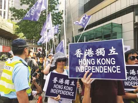 Pro-independence protesters supporting freedom of expression take part in a demonstration outside the police headquarters in Hong Kong yesterday.