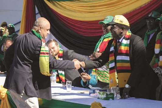 Zimbabwean President Emmerson Mnangagwa shakes hands with representative after addressing farmers and businessmen from the Zimbabwean White community in Harare.
