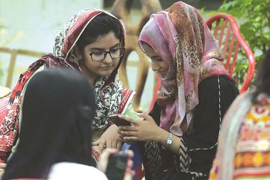 In this picture taken on July 12, students use their smartphones at a campus in Islamabad. A titanic 46mn people below the age of 35 are registered to vote in nationwide elections on July 25 u2013 many of them savvy social media users who are utilising platforms such as YouTube and Facebook Live to undermine traditional voting patterns by posting videos calling out the powerful.