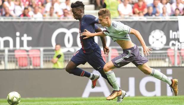 Paris Saint-Germainu2019s Timothy Weah (left) vies for the ball with Bayern Munichu2019s Josip Stanisic during the International Champions Cup match at the Worthersee Stadium in Klagenfurt, Austria, yesterday. (AFP)