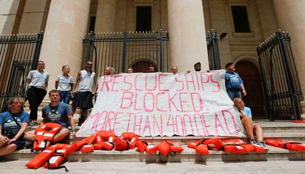 Crew members of NGO Sea-Watch protest outside the Courts of Justice during the arraignment of Claus-Peter Reisch, the captain of the charity ship MV Lifeline in Valletta, Malta
