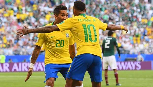 Brazil's forward Roberto Firmino (L) celebrates with Brazil's forward Neymar