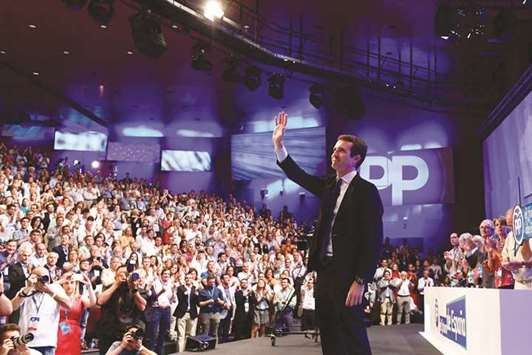 Casado acknowledges applause after being chosen as the next leader of the Popular Party (PP) at the end of a party meeting in Madrid.