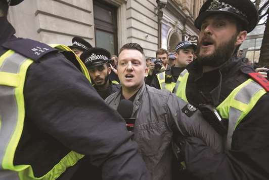 In this file photo taken on April 1 last year, Yaxley-Lennon, AKA Tommy Robinson, former leader of the EDL, is escorted by police from a Britain First march and an EDL march in central London.