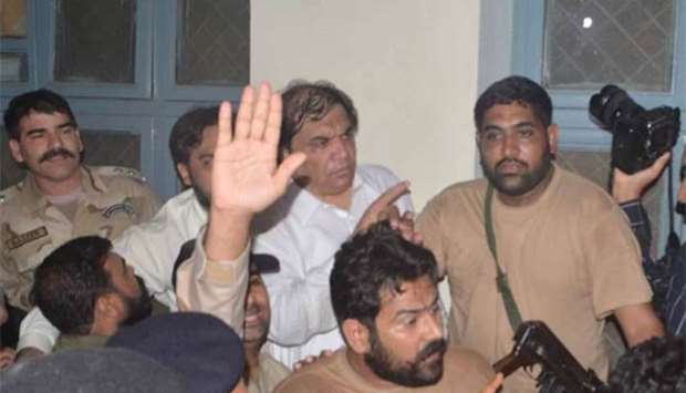 Security officials escort Hanif Abbasi (centre) after an anti-narcotics court sentenced him to life imprisonment in Rawalpindi on Saturday.