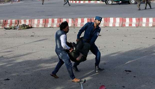 Members of Afghan security forces carry a wounded man at the site of a blast in Kabul. Reuters