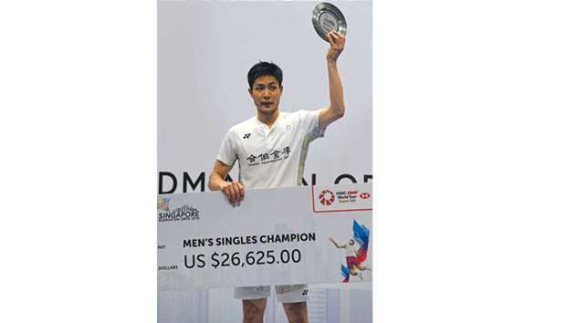 Chou Tien Chen of Taiwan poses with his trophy after winning against compatriot Hsu Jen Hao during the menu2019s singles final at the Singapore Open in Singapore yesterday. (AFP)
