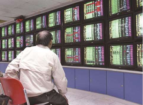 An investor watches stock screens at a brokerage in Taipei. Domestic investors hunting for dividends are propping up Taiwanu2019s stock market, while foreigners concerned about China-US trade tensions flee.