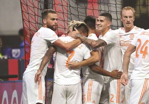 Atlanta United forward Josef Martinez (No 7) celebrates with teammates after scoring his second goal against DC United in at Mercedes-Benz Stadium. PICTURE: USA TODAY Sports