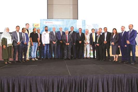 Aamal Trading and Distribution and Total Lubricants officials along with customers at the event.