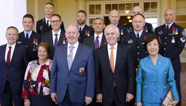 Australia's Craig Challen and Richard Harris, who were part of the Thailand cave rescue team, stand together with members of the Australian Federal Police, Governor-General Peter Cosgrove, Prime Minister Malcolm Turnbull and other officials after a ceremony at Government House in Canberra on Tuesday.