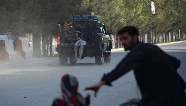 An Afghan police pickup truck transports injured victims following a suicide attack in Kabul on Sunday.