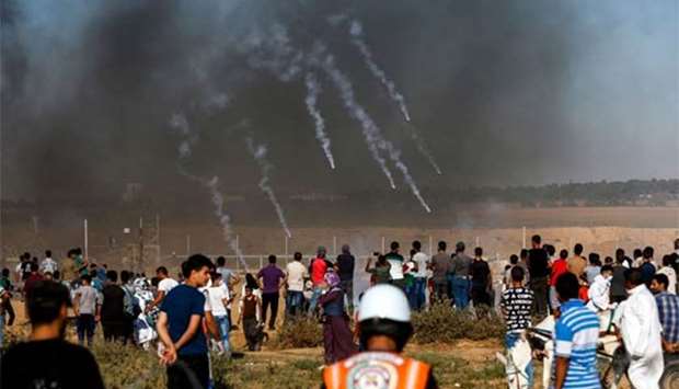 Tear gas canisters fired by Israeli forces landing amidst protesters along the border with Israel east of Khan Yunis in Gaza Strip on July 20.