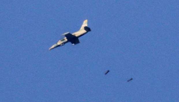 A picture taken on July 23, 2018 from the Israeli-annexed Golan Heights shows a warplane dropping a payload in the southwestern Syrian province of Daraa during a Syrian-government-led offensive in the area.