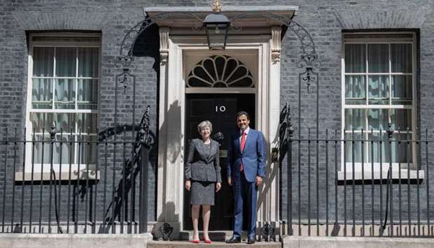 Britain's Prime Minister Theresa May greets His Highness the Amir Sheikh Tamim bin Hamad Al-Thani on the steps of 10 Downing Street in London