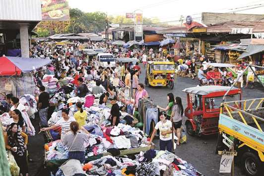 Shoppers browse stalls at a market in Davao, Mindanao. As part of President Duterteu2019s u201cBuild.Build.Buildu201d programme, plans are to issue Islamic bonds, or sukuk, to fund large infrastructure projects for the Mindanao island group and also raise funds for the rebuilding of Marawi City.