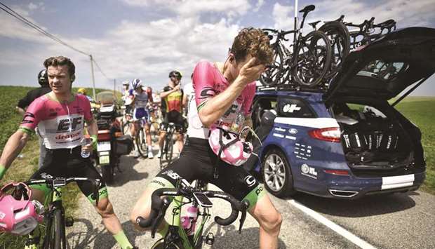 Riders clean their eyes after tear gas was used during a farmersu2019 protest who attempted to block the stageu2019s route, during the 16th stage of the Tour de France cycling race in southwestern France. (AFP)